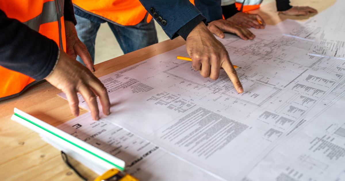 engineered-fill-pre-spec-service Construction contractors and engineers reviewing pre-spec services and blueprints